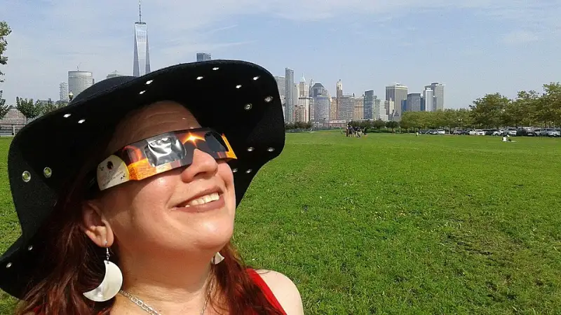 People watching a solar eclipse wearing certified eclipse glasses