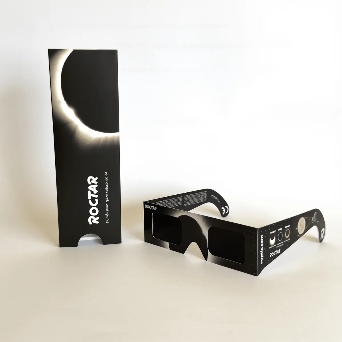 The ROCTAR case standing upright with the solar corona printed on it and the ROPTIC eclipse glasses in front
